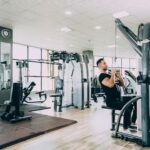 woman in black tank top and black pants exercising