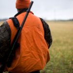 man in orange and black backpack