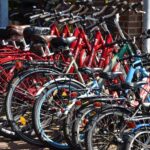 lined red, blue, and black bicycles on display