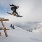 Man in Black Snowboard With Binding Performs a Jump