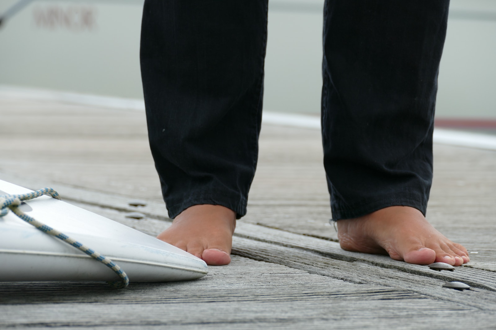 a person standing on a dock next to a white object