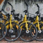 yellow and black bicycle leaning on wall