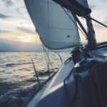 white sailing boat on body of water